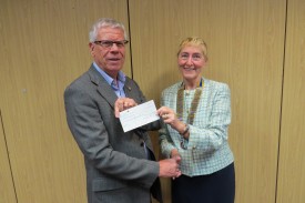 Jeff Reading receives a cheque on behalf of Cancer Research UK
