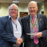 President John Taylor presents donation to John Miles 